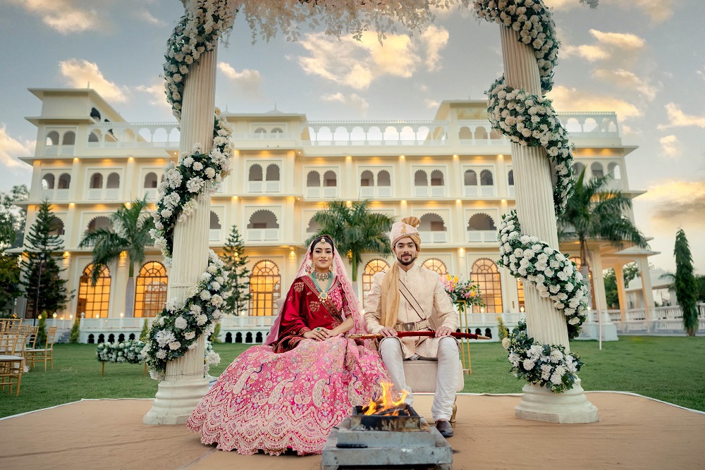 couple is sitting in the destination wedding of udaipur